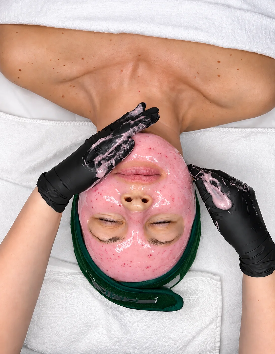 Pink Hydrojelly mask being applied during a facial treatment