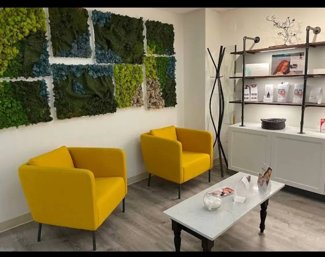 Inside SBW Beauty studio in Peabody with yellow chairs and product shelving